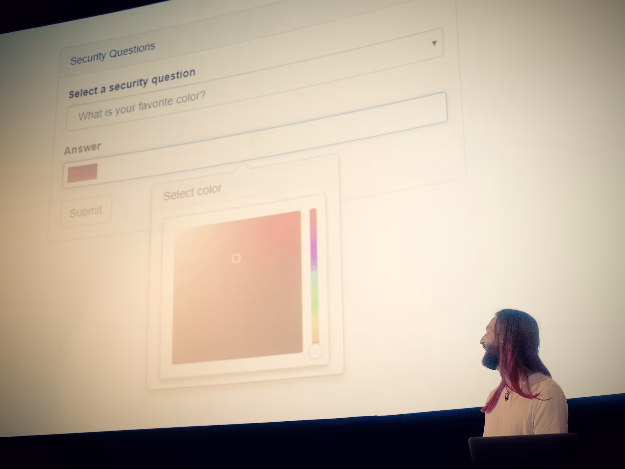 Blaine looks on at the screen where the user is prompted to pick their favourite colour from a full 360 degree colour wheel